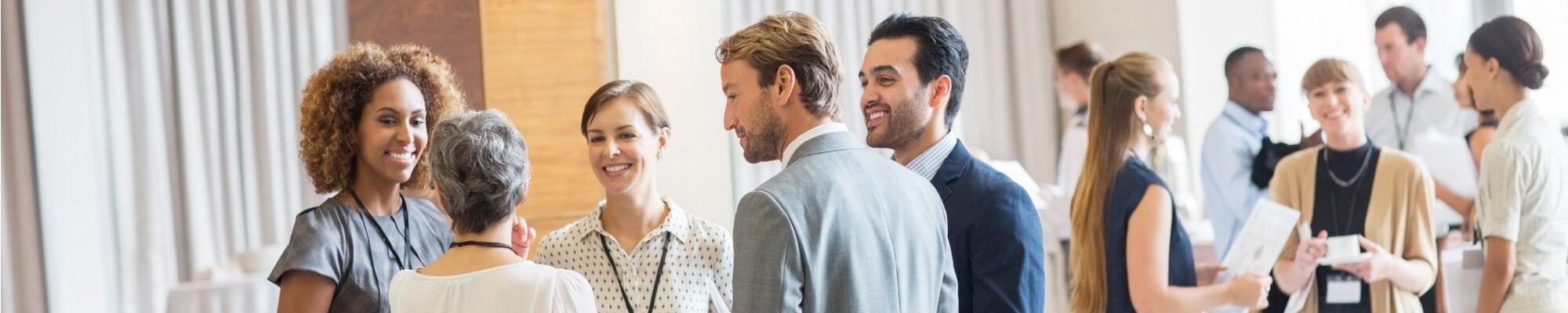 group-of-business-people-standing-in-hall-smiling-and-talking-picture-id530685719 (1)