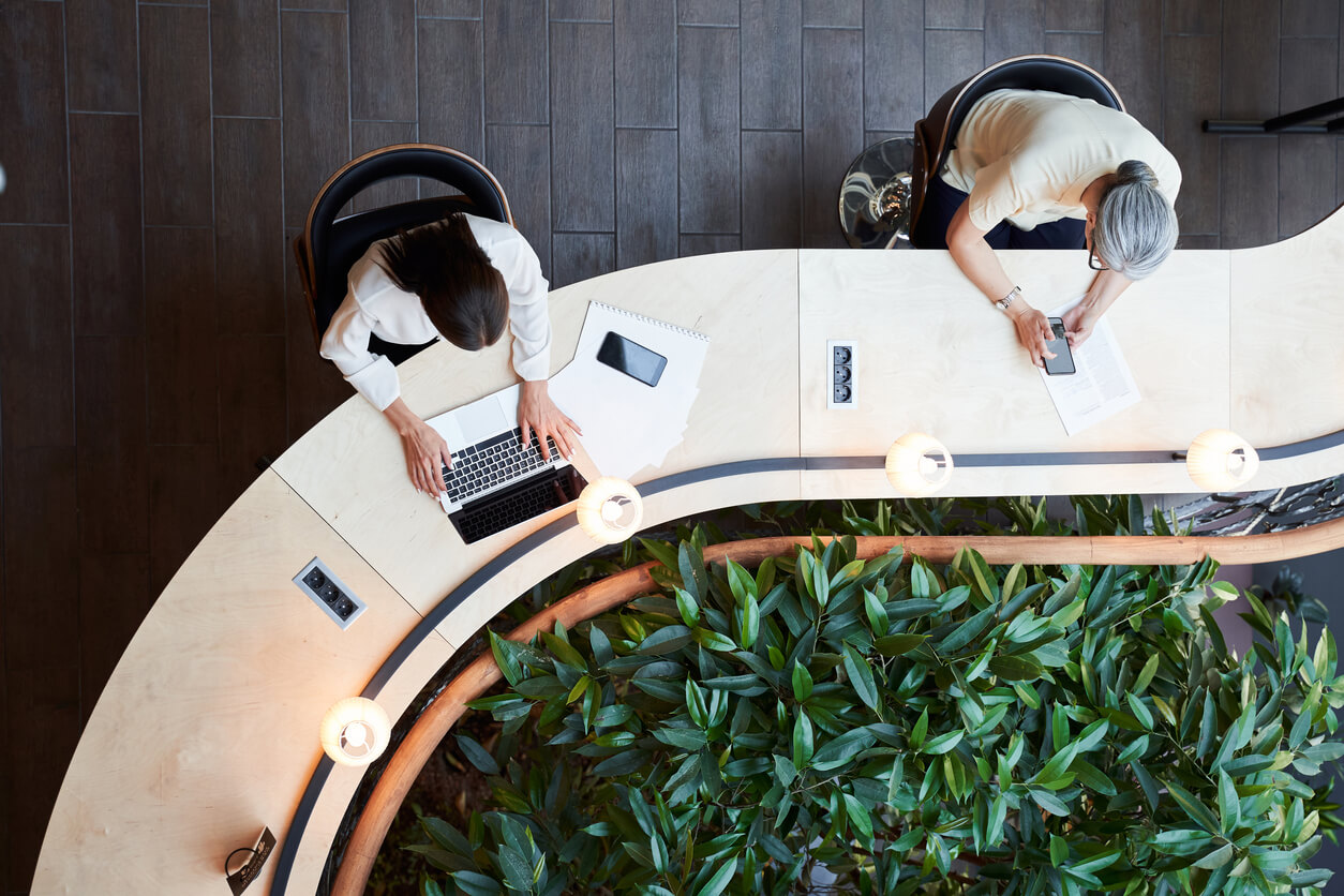 Young student and adult woman working at the same desk