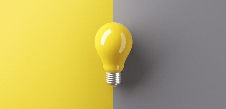 Ideas concepts, Creativity inspiration, White Lightbulb on grey and yellow background.