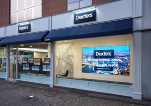 Video walls at storefront of Dexter London Estate Agents