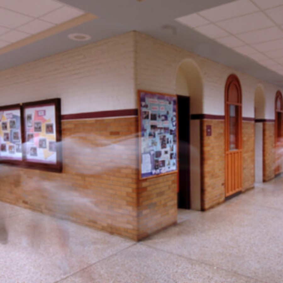 Bright school hallway with lockers and windows, ideal for IAdea campus digital signage displays