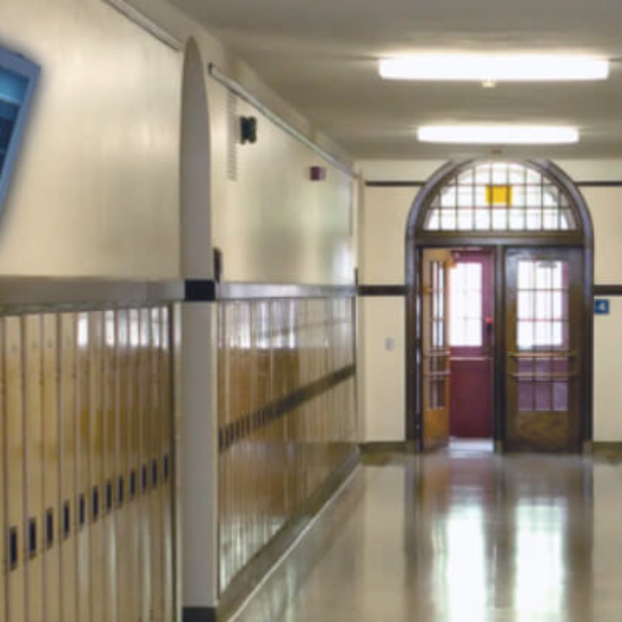 School corridor with wooden lockers and natural light for IAdea campus wayfinding displays