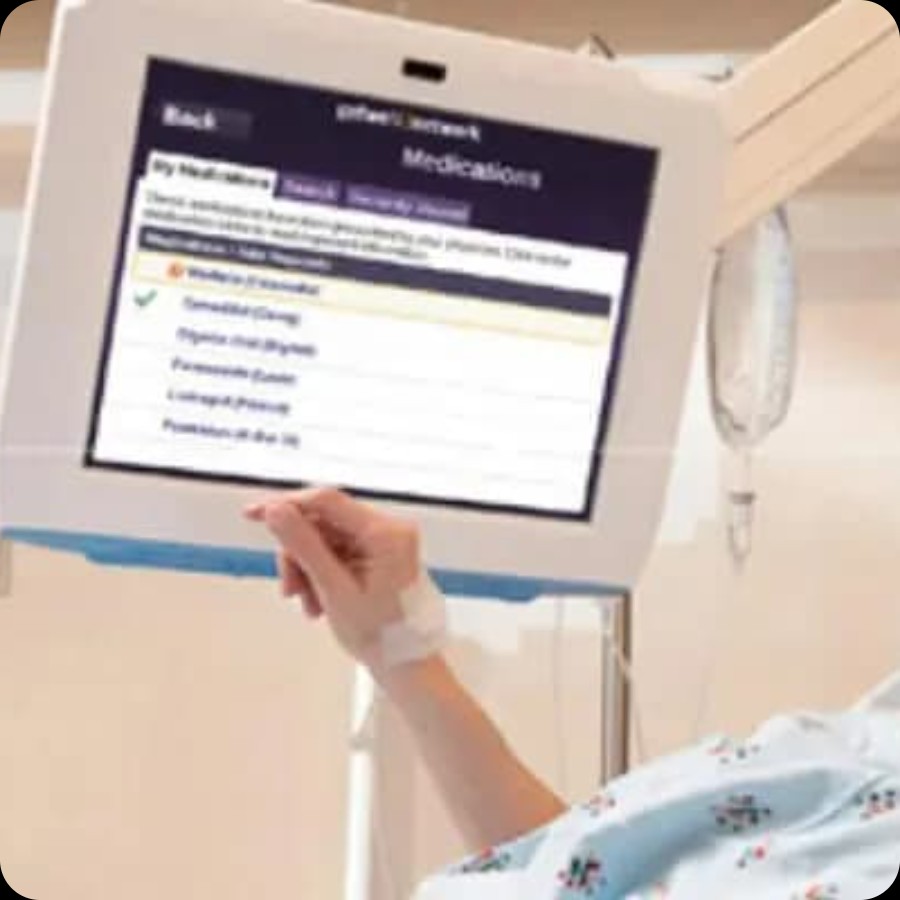 Hospital patient room with bed and equipment, suitable for IAdea bedside entertainment displays