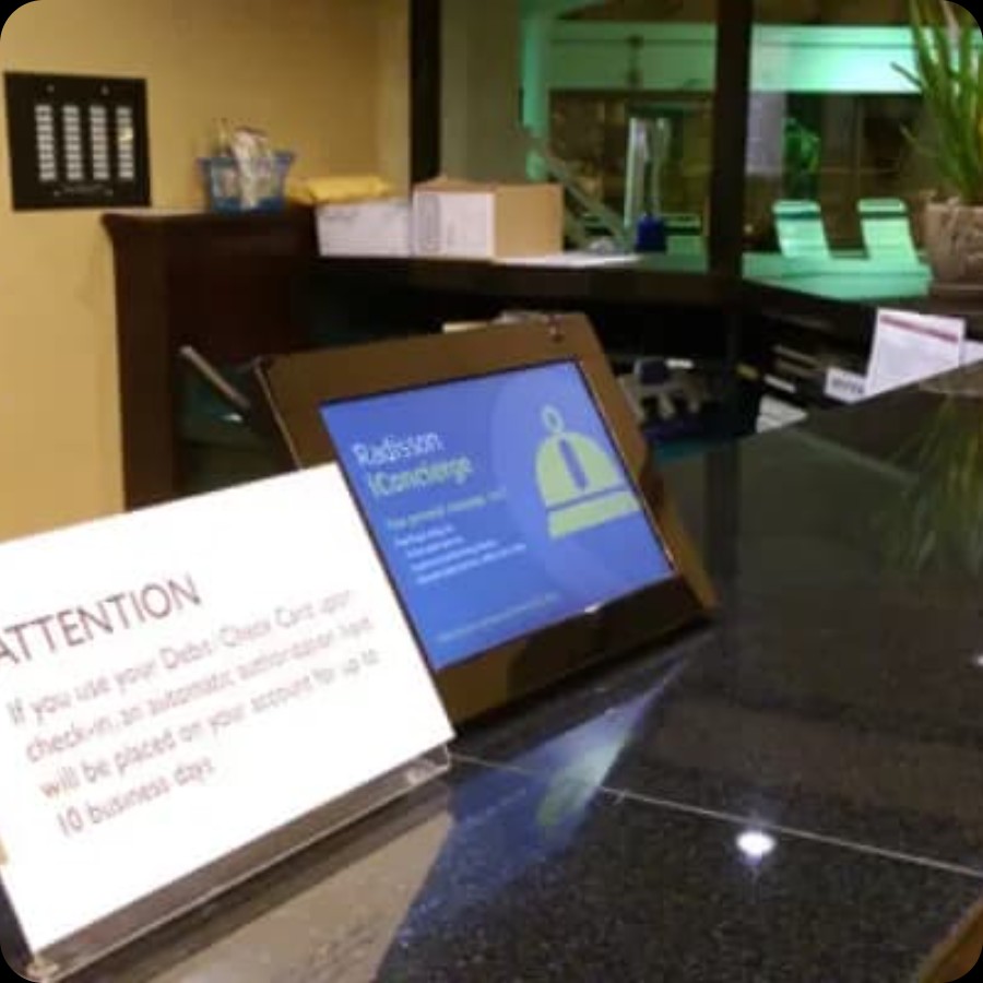 Modern hotel reception area with desk and lobby space for IAdea hospitality surveillance and signage