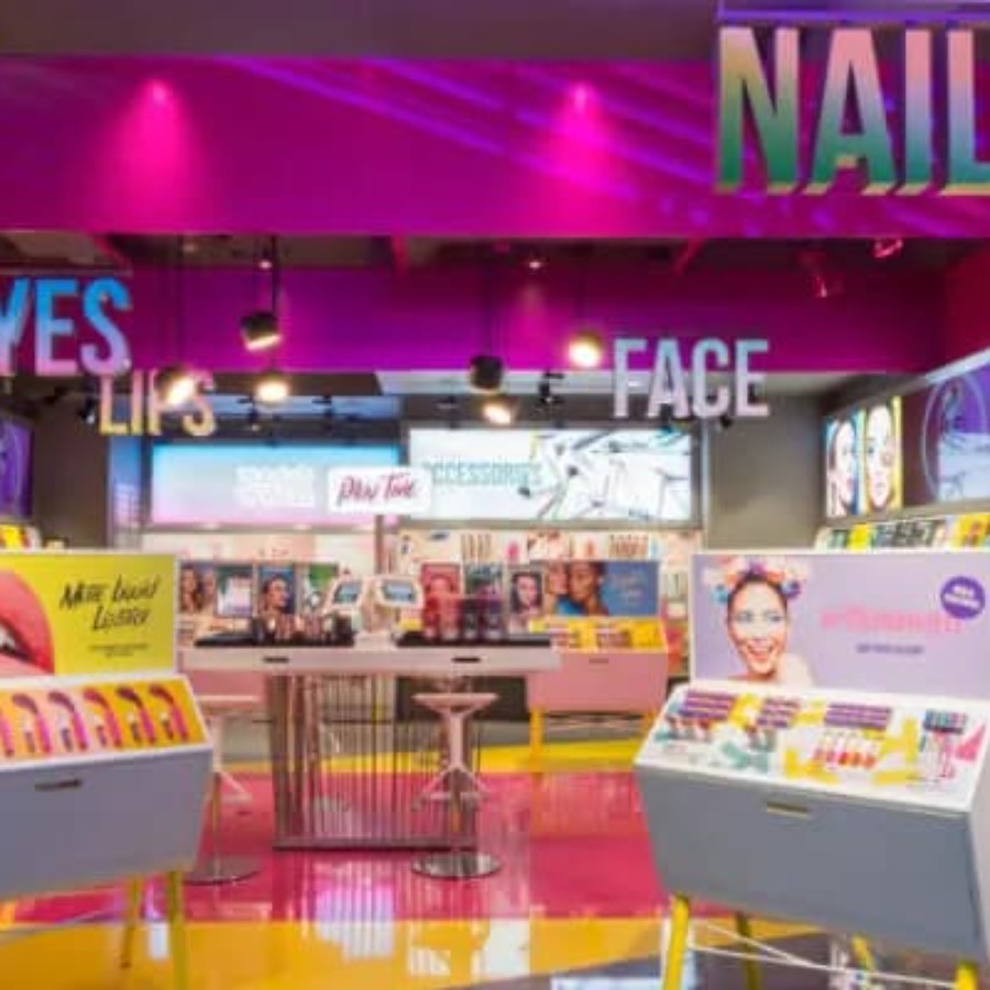 Interior of a cosmetics store with illuminated display shelving for IAdea digital signage